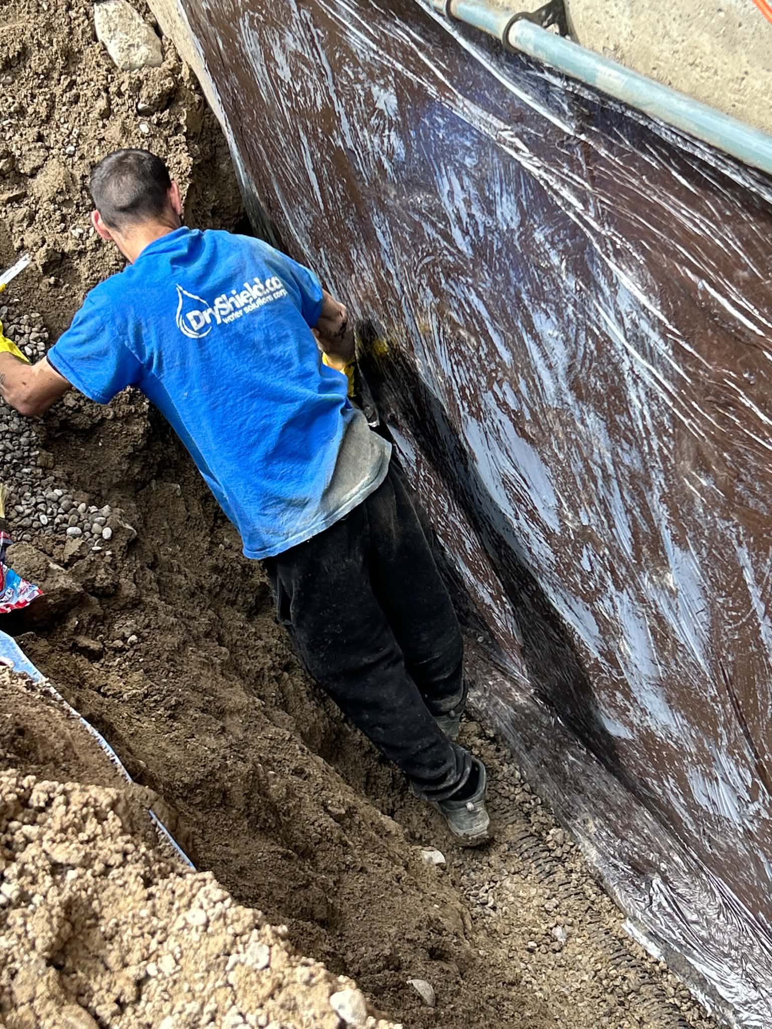 Dryshield interior basement waterproofing installation showing sub-floor drainage and sump pit during an Alliston, Ontario job